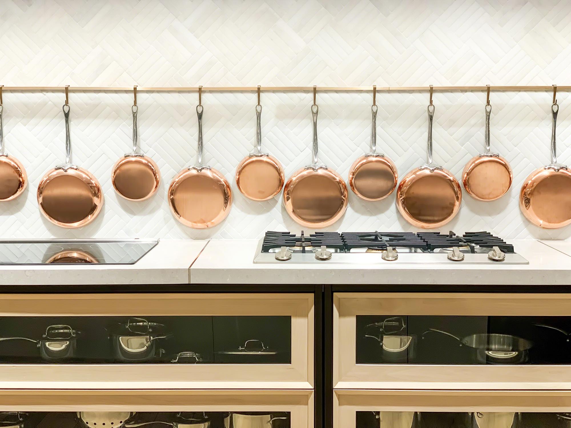 Entrance to a bright culinary studio with brass fixtures